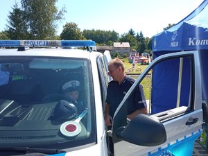 Przeworscy policjanci na pikniku rodzinnym w Kańczudze pokazują dzieciom radiowóz orz sprzęt policyjny